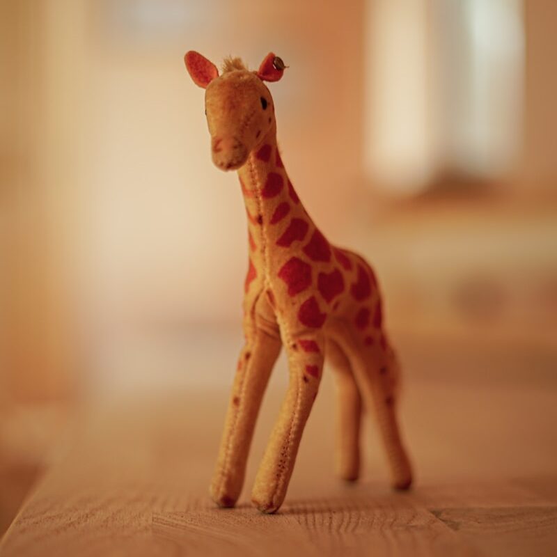giraffe figurine on brown textile